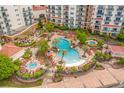 Aerial view showcasing the resort's large swimming pool area with ample seating, hot tubs, and lush landscaping at 8121 Amalfi Pl. # 4706, Myrtle Beach, SC 29572