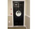 Close-up of a stylish black front door with decorative wreath and unit number at 9 Pistachio Loop # B, Murrells Inlet, SC 29576