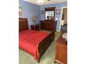 Comfortable bedroom with wood furniture, red bedding, and decorative wall art at 9779 Leyland Dr. # 3, Myrtle Beach, SC 29572