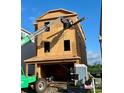 New construction of a three-story home with a two-car garage at 1105 Salt Windy Way, North Myrtle Beach, SC 29582