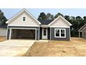 Newly constructed single-story home with a two-car garage and modern color scheme at 122 Westfield Circle, Conway, SC 29526
