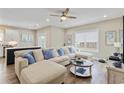 Bright living room with a sectional sofa, wood floors, and access to the outdoor balcony at 141 Marblehead Dr., Little River, SC 29566