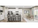 Bright kitchen featuring white cabinets, stainless steel appliances, and an eat-in dining area at 1517 Hope Pointe Dr, North Myrtle Beach, SC 29582