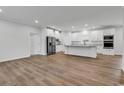 Bright, open-concept kitchen featuring white cabinetry, stainless steel appliances, and wood-look flooring at 1529 Bucksport Rd., Conway, SC 29527