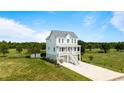 Beautiful two-story home featuring a charming white facade, a metal roof, and an inviting front porch at 1716 Cravens St., Georgetown, SC 29440
