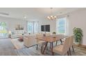 Well-lit dining area connected to living room with modern furniture and view to outside at 182 Foxford Dr., Conway, SC 29526