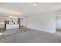 Bright living room featuring neutral carpet, gray walls, open floor plan to kitchen at 182 Foxford Dr., Conway, SC 29526