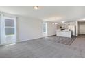 Open concept living area with plush carpeting, bright windows and view into the kitchen at 182 Foxford Dr., Conway, SC 29526