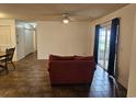 Open living room featuring a cozy sofa and access to a sliding glass door to a porch with natural light at 197 Charter Dr. # D1, Longs, SC 29568