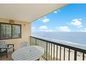 Balcony with ocean view, seating for two, offers a relaxing outdoor space at 201 S Ocean Blvd. # 1106, North Myrtle Beach, SC 29582