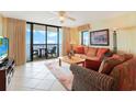 Comfortable living room with sliding glass door to balcony and ocean view at 201 S Ocean Blvd. # 1106, North Myrtle Beach, SC 29582