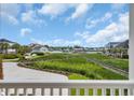Expansive waterfront views from a private balcony overlooking lush greenery and serene waterways, creating a peaceful retreat at 214 Olde Harbour Ct, Little River, SC 29566