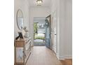 Bright foyer with wood flooring, a console table, and a view of the home's exterior at 223 Southgate Ct., Pawleys Island, SC 29585
