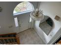 View of foyer with chandelier, tiled floors, large window and arched transom letting in bright natural light at 2862 Loblolly Ave., Little River, SC 29566