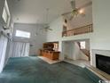 View of living room showing stairs, fireplace, bar, and large windows at 2862 Loblolly Ave., Little River, SC 29566