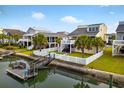 Scenic backyard with lush lawn, inviting dock, and charming waterfront views from multiple properties at 39 Newport St., Ocean Isle Beach, NC 28469