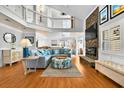Spacious living room with soaring ceilings, a cozy stone fireplace, and stylish decor at 39 Newport St., Ocean Isle Beach, NC 28469