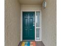 A charming entryway with a painted front door, decorative sidelight window, and textured wall at 4505 S Ocean Blvd. # 5D, North Myrtle Beach, SC 29582
