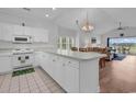 Bright kitchen with white cabinets, countertops, and appliances, open to dining and living areas at 4811 Orchid Way # 301, Myrtle Beach, SC 29577