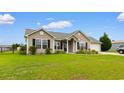 Well-maintained one-story house featuring manicured front yard and attractive landscaping at 520 Winged Elm St., Loris, SC 29569