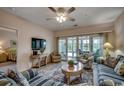 Comfortable living room with a TV and stylish furniture, next to an inviting sunroom at 601 Hillside Dr. N # 3704, North Myrtle Beach, SC 29582