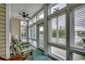 Relaxing sunroom with comfortable seating, lots of natural light, and a beautiful view at 601 Hillside Dr. N # 3704, North Myrtle Beach, SC 29582