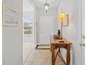 Bright foyer with tiled floors, a console table with a decorative lamp, and a front door at 6203 Catalina Dr. # 212, North Myrtle Beach, SC 29582