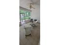 Cozy screened-in patio with comfortable seating, ceiling fan, and views of the backyard at 700 Two Rivers Ct., Myrtle Beach, SC 29579