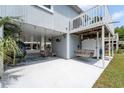 Charming outdoor space with a swing, seating area, and tropical plants for relaxing at 820 9Th Ave. S, North Myrtle Beach, SC 29582