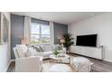 Bright living room with neutral décor and a large window at 857 Farmers Passage Loop, Loris, SC 29569