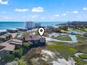 Aerial perspective of condo reveals its location nestled between a picturesque waterway and the ocean at 9501 Shore Dr. # A-311, Myrtle Beach, SC 29572