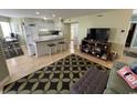 Cozy open-concept living room and kitchen with breakfast bar and modern appliances at 1101 Possum Trot Rd. # A202, North Myrtle Beach, SC 29582