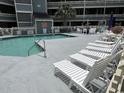 Relaxing pool area with lounge chairs and well-maintained swimming pool near the residential building at 1101 Possum Trot Rd. # A202, North Myrtle Beach, SC 29582