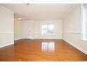 Bright living room with hardwood floors, a window, and neutral paint, offering a versatile space at 112 Molinia Dr., Murrells Inlet, SC 29576