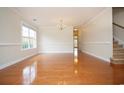 Spacious living room featuring hardwood floors, a large window, and neutral paint at 112 Molinia Dr., Murrells Inlet, SC 29576