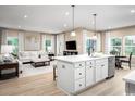Open concept living room and kitchen area with lots of natural light and modern decor at 1308 Piper Glen Dr, Sunset Beach, NC 28468