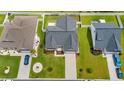 Aerial view of a home with a landscaped yard, driveway, and neighboring houses at 131 Crabapple Dr., Longs, SC 29568