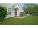 A quaint entrance with a green glass front door and manicured lawn at 153 Wimbledon Way # 153, Murrells Inlet, SC 29576