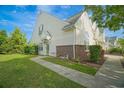 A lush green lawn and landscaped garden beds grace the front of this townhome at 153 Wimbledon Way # 153, Murrells Inlet, SC 29576