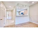 Inviting condo entryway featuring wood flooring, coat closet and a view to the kitchen at 1550 Spinnaker Dr. # 3123, North Myrtle Beach, SC 29582