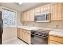 A close up of the kitchen featuring wood cabinets, white countertops, and modern appliances at 1550 Spinnaker Dr. # 3123, North Myrtle Beach, SC 29582