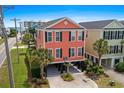 Coral stilt home with black shutters, basketball hoop, and covered parking under the house at 1617 N Dogwood Dr. N, Surfside Beach, SC 29575