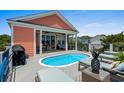 Relaxing pool deck with outdoor furniture and grill, ideal for entertaining by the pool at 1617 N Dogwood Dr. N, Surfside Beach, SC 29575