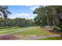 Scenic view of a lush green golf course lined with trees and a winding path, perfect for outdoor recreation at 1969 Governors Landing Rd. # 224, Murrells Inlet, SC 29576