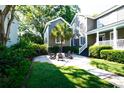 Cozy backyard featuring a fire pit, gravel patio, lush greenery, and comfortable seating at 203 Broad St., Georgetown, SC 29440