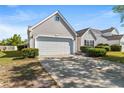 Charming home featuring a two-car garage, manicured landscaping, and a paved driveway at 2336 Windmill Way, Myrtle Beach, SC 29579