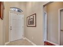 Inviting foyer with tile flooring, a front door with transom window, and neutral wall paint at 24 Willowbend Dr., Murrells Inlet, SC 29576
