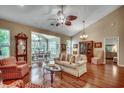 Spacious living room with hardwood floors, large windows, and elegant decor, perfect for gatherings at 24 Willowbend Dr., Murrells Inlet, SC 29576