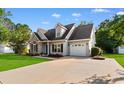 Attractive home with a well-maintained lawn and a long driveway leading to a one-car garage at 2595 Buck Scrape Rd., Myrtle Beach, SC 29588