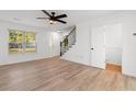 Bright living room with hardwood floors, a ceiling fan and stairs to the upper level at 2595 Buck Scrape Rd., Myrtle Beach, SC 29588